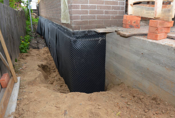 SJ Waterproofing Pros technician performing targeted Interior Drainage System assessment in Medford, WI
